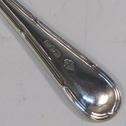 A large and very elegant set of Antique Edwardian Sterling Silver grape-fruit spoons, in the double-struck Reed and Ribbon pattern, having plain pointed oval bowls, and all in their original white satin and maroon velvet-lined presentation box. These beautiful antique silver grape-fruit spoons were made by William Hutton and Sons of London in 1908. The dimensions of these fine hand-made silver grapefruit spoons are length 15 cms (6 inches), and they weigh a total of 181g (5.8 troy ounces).  