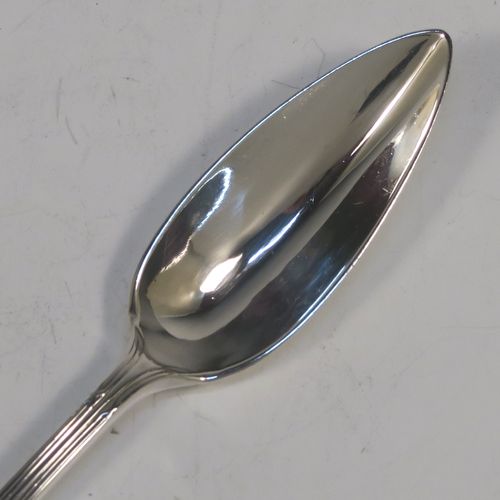 A large and very elegant set of Antique Edwardian Sterling Silver grape-fruit spoons, in the double-struck Reed and Ribbon pattern, having plain pointed oval bowls, and all in their original white satin and maroon velvet-lined presentation box. These beautiful antique silver grape-fruit spoons were made by William Hutton and Sons of London in 1908. The dimensions of these fine hand-made silver grapefruit spoons are length 15 cms (6 inches), and they weigh a total of 181g (5.8 troy ounces).  