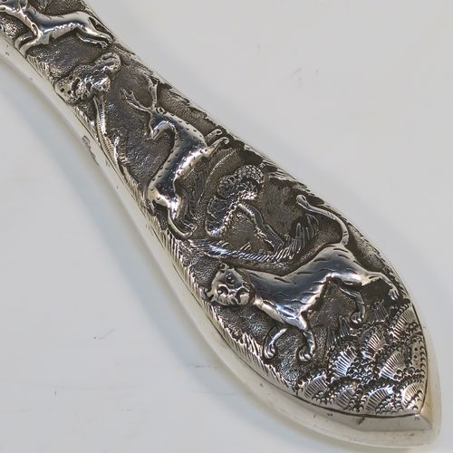 A beautiful Antique Victorian Indian Sterling Silver hand-mirror, having an oval body with a hand-chased scene of animals including lions, deer, dogs, leopards, and elephants, surrounding a central vacant round  cartouche, and an oval mounted mirror in a plain frame. This fantastic silver hand mirror was probably made for the Indian market in ca. 1880. The dimensions of this fine hand-made silver hand mirror are length 28 cms (11 inches), and width of main body 11 cms (4.3 inches).   