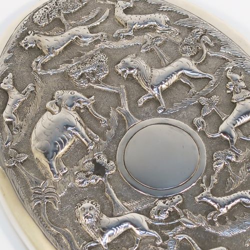 A beautiful Antique Victorian Indian Sterling Silver hand-mirror, having an oval body with a hand-chased scene of animals including lions, deer, dogs, leopards, and elephants, surrounding a central vacant round  cartouche, and an oval mounted mirror in a plain frame. This fantastic silver hand mirror was probably made for the Indian market in ca. 1880. The dimensions of this fine hand-made silver hand mirror are length 28 cms (11 inches), and width of main body 11 cms (4.3 inches).   