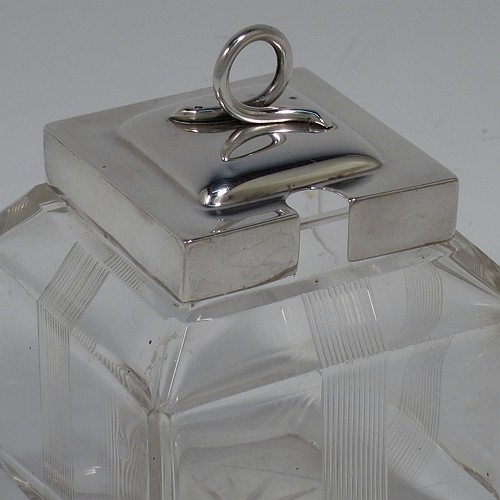 A very pretty Antique Edwardian sterling silver and hand-cut crystal jam, honey, or preserve jar, having a square body decorated with hand-engraved reeded vertical bands, and with sloping upper and lower borders, together with a square stepped pull-off silver lid with looped handle, and all sitting on a star-cut base. Made by Heath & Middleton of Birmingham in 1908. The dimensions of this fine hand-made antique silver and crystal jam or honey jar are height 9.5 cms (3.75 inches), and 7 cms (2.75 inches) square.   