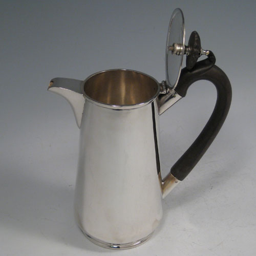    Sterling silver very plain straight-sided hot water / milk jug with wooden handle and finial. Made by J.B. Chatterley & Sons of Birmingham in 1912. Height 18 cms (7 inches), length (across handle and spout) 16 cms (6.5 inches). Weight approx. 11 troy ounces (341g).