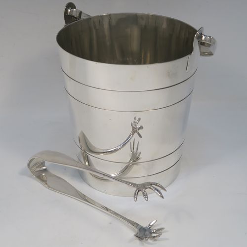 A very stylish Art Deco Silver Plated ice bucket, having a plain round body with tapering straight sides and hand-chased reeded decoration, an internal removable dry ice drainer, a pair of ice tongs, and with a hinged loop handle, and all sitting on a flat base. This elegant silver-plated ice bucket was made in ca. 1930. The dimensions of this fine hand-made silver-plated ice bucket are height (not including handle) 16 cms (6.3 inches), and diameter at lip 14.5 cms (5.75 inches).   