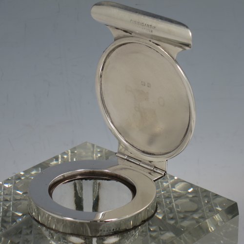 An Antique Edwardian Sterling Silver and hand-cut crystal inkstand, having a square body with chamfered corners, a plain round silver mount with a hinged lid and an unusual attached pen holder, and all sitting on a hand-cut hobnail pattern flat base. Made by Finnigans Ltd., of Birmingham in 1902. The dimensions of this fine hand-made antique silver and crystal inkstand are height 9 cms (3.5 inches), and 10 cms (4 inches) square.   