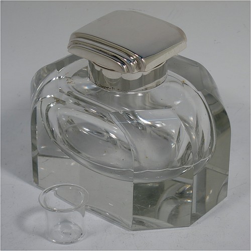 A very handsome Art Deco Sterling Silver and hand-cut crystal inkstand, having a rectangular body with rounded corners and panelled faces, a plain round silver mount with a square hinged lid having hand-chased stepped decoration, a removable small glass liner, and all sitting on a plain cut flat base. Made by the F. C. Richards of Birmingham in 1938. The dimensions of this fine hand-made silver and crystal inkstand are height 8.5 cms (3.25 inches), length 10 cms (4 inches), and width 7 cms (2.75 inches).    