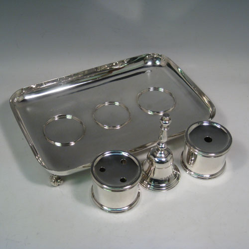 Sterling silver very large and heavy table inkstand, having a plain rectangular body, with central bell, inkwell, and pen-holder (both with glass liners), all sitting on four cast scroll feet. Made by Robert Comyns of London in 1935. Length 32 cms (12.5 inches), width 21 cms (8.25 inches). Total weight approx. 1,886g (60.8 troy ounces).