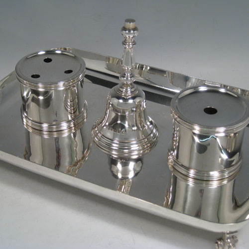 Sterling silver very large and heavy table inkstand, having a plain rectangular body, with central bell, inkwell, and pen-holder (both with glass liners), all sitting on four cast scroll feet. Made by Robert Comyns of London in 1935. Length 32 cms (12.5 inches), width 21 cms (8.25 inches). Total weight approx. 1,886g (60.8 troy ounces).