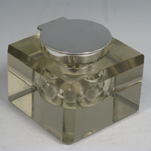 An Antique Victorian Sterling Silver and hand-cut crystal inkstand paper weight, having a square body with chamfered upper edges, a plain round mount and a flat-topped hinged lid, and with a removable glass liner, all sitting on a flat-cut plain base. Made by John Grinsell and Sons of London in 1898. The dimensions of this fine antique silver and crystal inkstand are height 7 cms (2.75 inches), and 9 cms (3.5 inches) square.