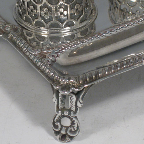    Antique Georgian sterling silver inkstand, having a rectangular body with gadroon and shell border, single pen-well, three hand-cut crystal bottles held within pierced inkwell galleries, all sitting on four cast foliate feet. The glass inkwells are for pens (quills), pounce, and ink. Made by William Plummer of London in 1772. Length 18 cms (7.25 inches), width 11 cms (4.25 inches), height 7.5 cms (3 inches). Weight approx. 240g (7.7 troy ounces).