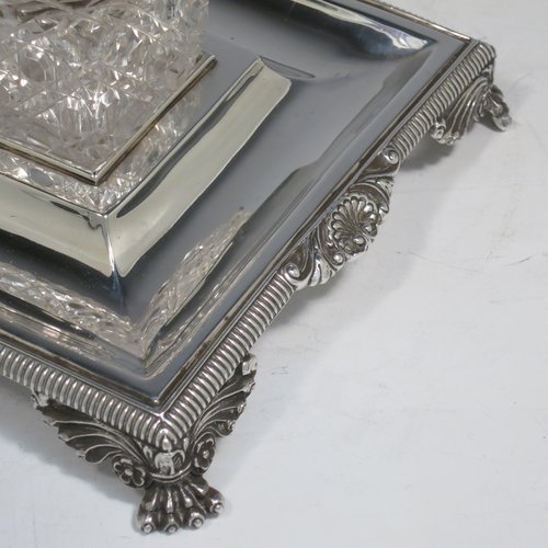 An Antique Victorian Sterling Silver inkstand, having a rectangular body with gadroon and shell border, two square hand-cut crystal removable ink bottles with round hinged lids, all sitting on four cast foliate and claw feet. Made by Henry Wilkinson & Co., of London in 1899. The dimensions of this fine hand-made antique silver double inkstand are length 25 cms (10 inches), width 16 cms (6.3 inches), height 8 cms (3.25 inches), and it weighs approx. 395g (12.6 troy ounces).