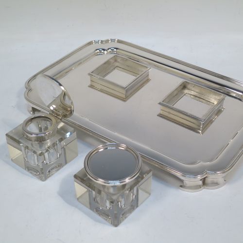 A very elegant and large Sterling Silver heavy table inkstand, having a plain rectangular body, with cut corners, two removable square crystal ink-wells with hinged round silver lids, all sitting on four cast flange feet. Made by Henry H. Plante of London in 1963. The dimensions of this fine hand-made table inkstand are length 25.5 cms (10 inches), width 17 cms (6.75 inches), and it weighs a total of approx. 650g (21 troy ounces).   