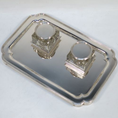 A very elegant and large Sterling Silver heavy table inkstand, having a plain rectangular body, with cut corners, two removable square crystal ink-wells with hinged round silver lids, all sitting on four cast flange feet. Made by Henry H. Plante of London in 1963. The dimensions of this fine hand-made table inkstand are length 25.5 cms (10 inches), width 17 cms (6.75 inches), and it weighs a total of approx. 650g (21 troy ounces).   