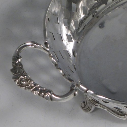 Antique Edwardian sterling silver jardinière, having an oval body with hand-pierced and engraved decoration in a basket-weave style, applied shell and scroll borders, with two cast floral handles, and sitting on four cast scroll feet. Made by Wakely & Wheeler of Chester in 1902. The dimensions of this fine hand-made silver table jardinière are length 35 cms (13.75 inches), width 20 cms (8 inches), height 11.5 cms (4.5 inches), and it weighs approx. 844g (27 troy ounces).  