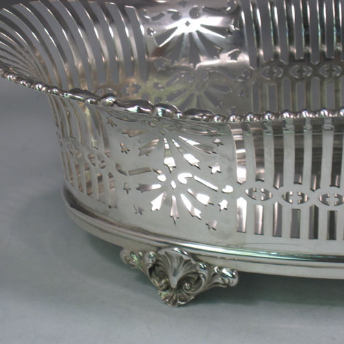 Antique Victorian silver (835 standard) jardinière, having an oval body, with hand-pierced geometrical and floral decoration, an applied shell and gadroon border, and sitting on four cast shell feet. Made in Austria (possibly) in ca. 1890. The dimensions of this fine hand-made jardinière are length 38 cms (16 inches), width 24 cms (9.5 inches), and height 13 cms (5 inches).