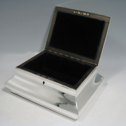    Antique Edwardian sterling silver jewelery box, having a plain rectangular baluster body, a plain hinged lid, keyhole and lock (original key missing), and blue velvet-lined interior. Made by William Comyns of London in 1904. Length 19.5 cms (7.75 inches), height 8.5 cms (3.3 inches), depth 16 cms (6.3 inches).