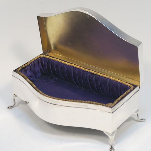 A very handsome Antique Sterling Silver jewelery box, having a dressing table style plain rectangular bow-fronted body, a plain and slightly domed hinged, a gold gilt and dark blue satin-lined interior, and all sitting on four cabriolet feet. This elegant antique silver jewellery box was made by Deakin and Francis of Birmingham in 1919. The dimensions of this fine hand-made antique silver jewellery box are width 13 cms (5 inches), depth 8 cms (3 inches), and height 5 cms (2 inches)  