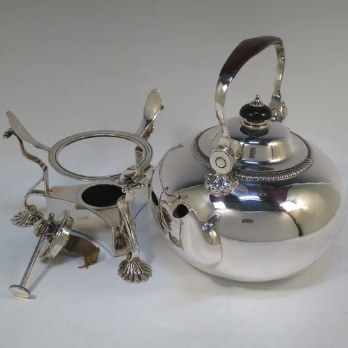 A very handsome Antique Victorian Sterling Silver tea kettle on a burner stand, having a plain round bellied body with an applied gadroon border, a lift-off lid with wooden finial, a leather covered hinged handle, and sitting on an original burner stand with removable central wick and three cast shell feet. Made by Joshua Vander of London in 1893. The dimensions of this fine hand-made antique silver kettle are length 21 cms (8.25 inches), height 27.5 cms (10.75 inches), width 18 cms (7 inches), and the total weight is approx. 770g (24.8 troy ounces).   