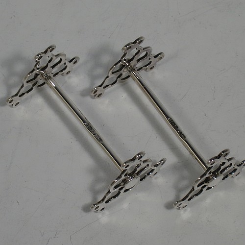 A very pretty Antique Sterling Silver pair of knife rests, with hand-pierced and scroll style rest ends, and plain round central struts. Made by James Dixon Sheffield in 1913. The dimensions of this fine hand-made pair of antique silver knife rests are length 7 cms (2.75 inches), height 4 cms (1.5 inches), and they weigh a total of approx. 47g (1.5 troy ounces).    