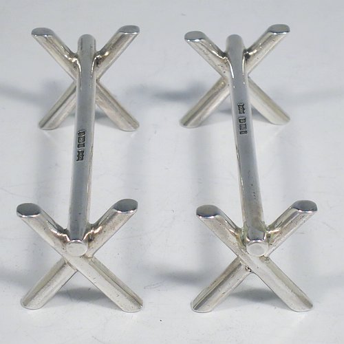 A Sterling Silver Art Deco pair of knife rests, with very plain geometric rest ends, and plain central struts. Made by Mappin & Webb of Sheffield in 1926. The dimensions of this fine hand-made pair of silver knife rests are length 9 cms (3.5 inches), height 3 cms (1.3 inches), and they weigh a total of approx. 128g (4 troy ounces).    