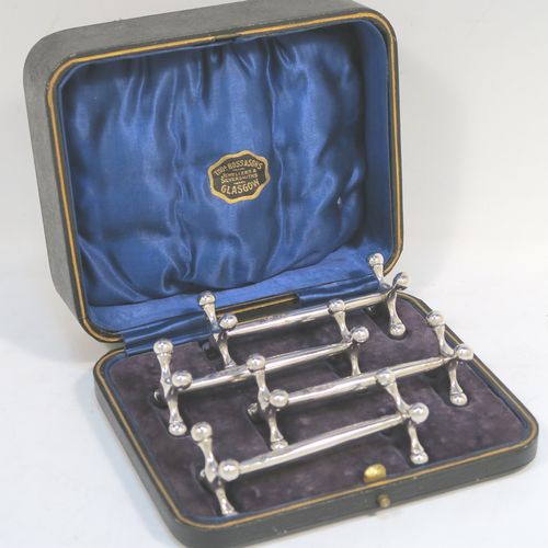 A handsome Sterling Silver set of four knife rests, with traditional cast Jack-style rest ends, and plain round central struts, all in their original dark blue satin and velvet-lined presentation box. Made by Martin Hall and Co., of Sheffield in 1922. The dimensions of this fine hand-made set of four silver knife rests are length 8.5 cms (3.3 inches), height 3 cms (1.25 inches), and they weigh a total of approx. 224g (7.2 troy ounces).  