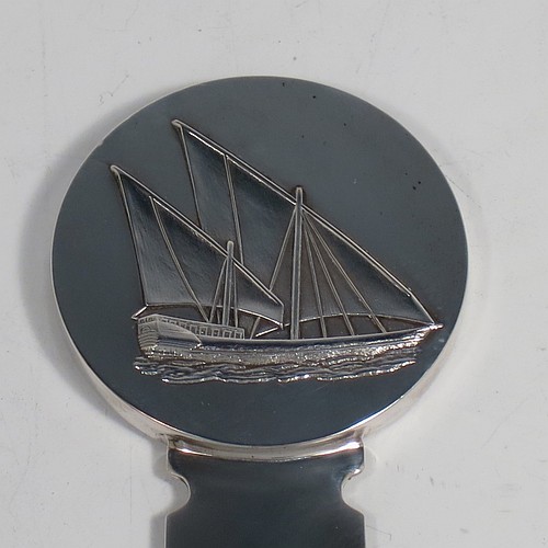 A very stylish Silver-Plated letter or envelope opener, having a very plain straight-sided blade with tapering point, attached to a heavy round handle with one side having a hand-chased schooner ship, and the reverse with a view of the Kuwaiti water towers. Made by Christofle of Paris, France, in circa. 1980. The dimensions of this fine hand-made silver plated envelope or letter opener are length 22 cms (8.6 inches), and diameter of handle 5 cms (2 inches). 