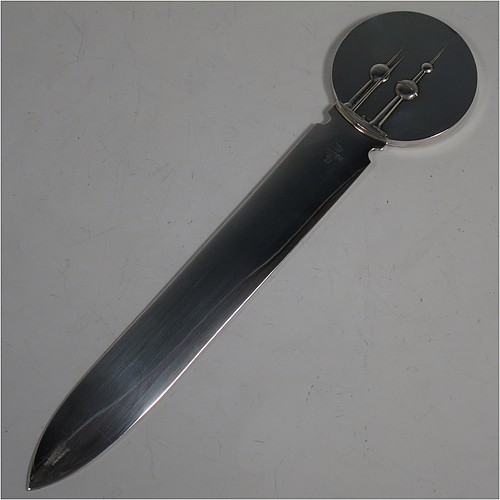 A very stylish Silver-Plated letter or envelope opener, having a very plain straight-sided blade with tapering point, attached to a heavy round handle with one side having a hand-chased schooner ship, and the reverse with a view of the Kuwaiti water towers. Made by Christofle of Paris, France, in circa. 1980. The dimensions of this fine hand-made silver plated envelope or letter opener are length 22 cms (8.6 inches), and diameter of handle 5 cms (2 inches). 