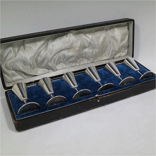 A handsome Antique Edwardian Sterling Silver set of six liqueor tots or measures, having very plain round bodies with tapering sides, sitting on round pedestal feet, and all fitted in their original satin and blue velvet-lined presentation box. Made by Walker and Hall of Birmingham in 1908. The dimensions of this fine hand-made antique silver liqueur tots are height 7.5 cms (3 inches), diameter at base 4.5 cms (1.75 inches), and the total weight is approx. 143g (4.6 troy ounces).    