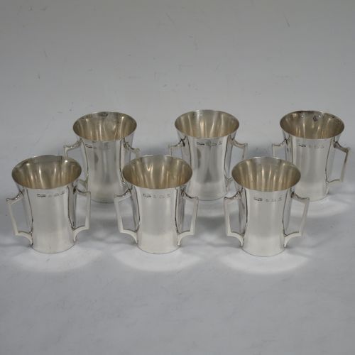 A handosme Antique Sterling Silver set of six liqueor tots or measures, having plain round bodies with tapering sides, three side-handles, and sitting on flat bases. Made by Mappin and Webb of Birmingham in 1915. The dimensions of this fine hand-made antique silver liqueur tot set are height 4 cms (1.5 inches), diameter at lip 4 cms (1.5 inches), and their total weight is approx. 165g (5.3 troy ounces).    