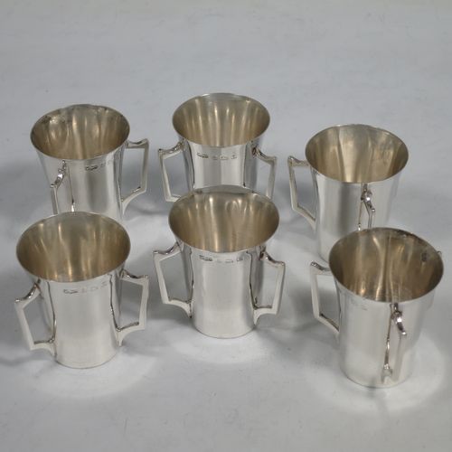 A handosme Antique Sterling Silver set of six liqueor tots or measures, having plain round bodies with tapering sides, three side-handles, and sitting on flat bases. Made by Mappin and Webb of Birmingham in 1915. The dimensions of this fine hand-made antique silver liqueur tot set are height 4 cms (1.5 inches), diameter at lip 4 cms (1.5 inches), and their total weight is approx. 165g (5.3 troy ounces).    