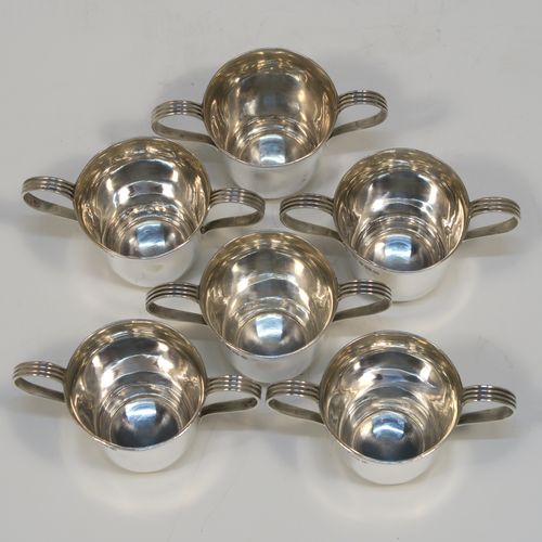 A handsome Antique Sterling Silver set of six liqueor tots or measures in a porringer style, having plain round bodies with tapering sides, two reeded side-handles, and sitting on flat bases. This elegant set of liqueur measures were made by Vale Brothers and Sermon of Birmingham in 1913. The dimensions of this fine hand-made antique silver liqueur tot set are height 4.5 cms (1.75 inches), diameter at lip 4 cms (1.5 inches), and their total weight is approx. 159g (5 troy ounces).  