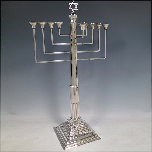 A rare and large Sterling Silver Hanukkah Menorah in a traditional Corinthian style, having a panelled and fluted column, sitting on a stepped base with bead borders. Made by Alexander Titlebaum of London in 1961. The dimensions of this fine hand-made silver menorah are height 46 cms (18 inches), spread across arms 26 cms (10.25 inches), and it weighs approx. 824g (26.5 troy ounces) Please note that this item is NOT filled so the whole weight is silver.    