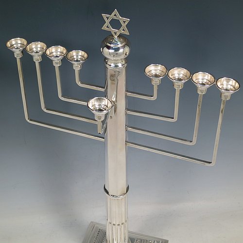 A rare and large Sterling Silver Hanukkah Menorah in a traditional Corinthian style, having a panelled and fluted column, sitting on a stepped base with bead borders. Made by Alexander Titlebaum of London in 1961. The dimensions of this fine hand-made silver menorah are height 46 cms (18 inches), spread across arms 26 cms (10.25 inches), and it weighs approx. 824g (26.5 troy ounces) Please note that this item is NOT filled so the whole weight is silver.    