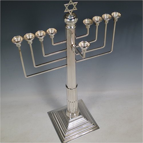 A rare and large Sterling Silver Hanukkah Menorah in a traditional Corinthian style, having a panelled and fluted column, sitting on a stepped base with bead borders. Made by Alexander Titlebaum of London in 1961. The dimensions of this fine hand-made silver menorah are height 46 cms (18 inches), spread across arms 26 cms (10.25 inches), and it weighs approx. 824g (26.5 troy ounces) Please note that this item is NOT filled so the whole weight is silver.    