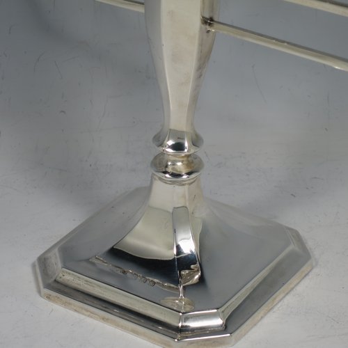 A Sterling Silver Hanukkah Menorah in an Art Deco style, having an octagonal panelled body sitting on a pedestal foot, with a removable Shamus candle holder. Made in Birmingham in 1948. The dimensions of this fine hand-made silver menorah are height 23 cms (9 inches), spread across arms 25 cms (9.75 inches), and it weighs approx. 248g (8 troy ounces) Please note that this item is not filled so the whole weight is silver.    