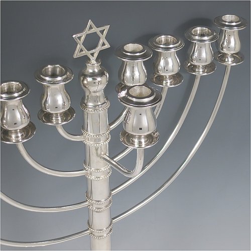 A rare and large Sterling Silver Hanukkah Menorah in a traditional style, having a round baluster body with hand-chased garlands of flowers, removable nozzles for cleaning, with bands of applied beading, and all sitting on a pedestal foot. Made by Morris Salkind of Birmingham in 1927. The dimensions of this fine hand-made silver menorah are height 49 cms (19.25 inches), spread across arms 33 cms (13 inches), and it weighs approx. 992g (32 troy ounces) Please note that this item is NOT filled so the whole weight is silver.    