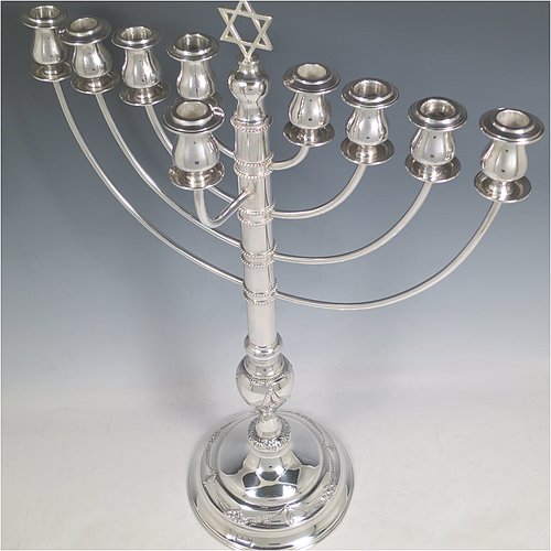 A rare and large Sterling Silver Hanukkah Menorah in a traditional style, having a round baluster body with hand-chased garlands of flowers, removable nozzles for cleaning, with bands of applied beading, and all sitting on a pedestal foot. Made by Morris Salkind of Birmingham in 1927. The dimensions of this fine hand-made silver menorah are height 49 cms (19.25 inches), spread across arms 33 cms (13 inches), and it weighs approx. 992g (32 troy ounces) Please note that this item is NOT filled so the whole weight is silver.    