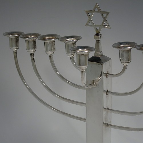 A Sterling Silver Hanukkah Menorah in an Art Deco style, having a plain panelled column, sitting on a stepped base. Made by Britton, Gould and Co., of Birmingham in 1936. The dimensions of this fine hand-made Art Deco silver menorah are height 25.5 cms (10 inches), spread across arms 24 cms (9.5 inches), and it weighs approx. 310g (10 troy ounces). Please note that this item is NOT filled so the whole weight is silver.   