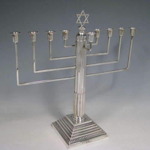 Sterling silver Menorah, having a stepped base with bead borders, and a fluted corinthian style column. Made in Birmingham in 1930. Height 28 cms (11 inches), spread across arms 28 cms (11 inches). Weight approx. 420g (13.5 troy ounces) Please note that this item is not filled. 
