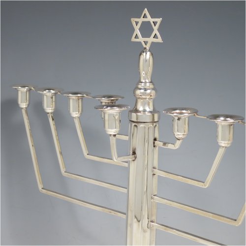 A Sterling Silver Menorah, having a Corinthian style body with a fluted column, and a stepped base with bead borders. Made in Birmingham in 1938. The dimensions of this fine hand-made silver menorah are height 33 cms (13 inches), spread across arms 30.5 cms (12 inches), and it weighs approx. 458g (14.8 troy ounces) Please note that this item is not filled.   