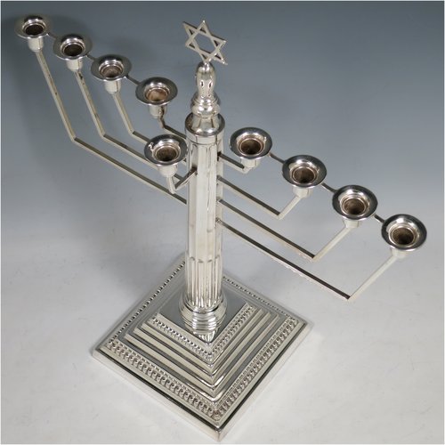 A Sterling Silver Menorah, having a Corinthian style body with a fluted column, and a stepped base with bead borders. Made in Birmingham in 1938. The dimensions of this fine hand-made silver menorah are height 33 cms (13 inches), spread across arms 30.5 cms (12 inches), and it weighs approx. 458g (14.8 troy ounces) Please note that this item is not filled.   