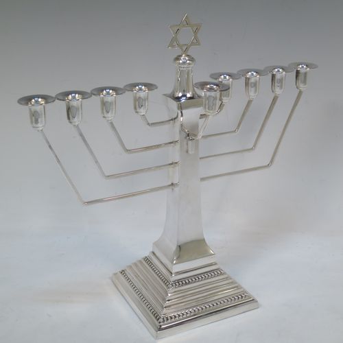 A very elegant Sterling Silver Hanukkah Menorah in an Art Deco style, having a square panelled body with bead-edged borders, a removable Shamus candle holder, and sitting on a pedestal foot. Made by Alexander Smith of Birmingham in 1977. The dimensions of this fine hand-made silver menorah are height 26 cms (10.25 inches), spread across arms 26 cms (10.25 inches), and it weighs approx. 352g (11.4 troy ounces) Please note that this item is not filled so the whole weight is silver.  