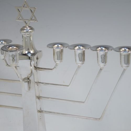 A very elegant Sterling Silver Hanukkah Menorah in an Art Deco style, having a square panelled body with bead-edged borders, a removable Shamus candle holder, and sitting on a pedestal foot. Made by Alexander Smith of Birmingham in 1977. The dimensions of this fine hand-made silver menorah are height 26 cms (10.25 inches), spread across arms 26 cms (10.25 inches), and it weighs approx. 352g (11.4 troy ounces) Please note that this item is not filled so the whole weight is silver.  