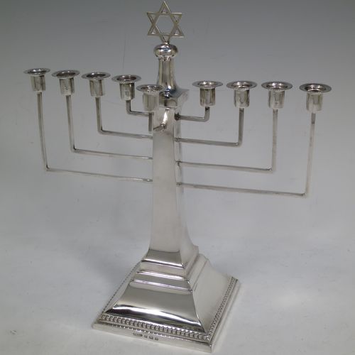 A very elegant Sterling Silver Hanukkah Menorah in an Art Deco style, having a square panelled body with bead-edged borders, and sitting on a pedestal foot. Made by Britten, Gould and Co., of Birmingham in 1931. The dimensions of this fine hand-made silver menorah are height 26.5 cms (10.5 inches), spread across arms 23.5 cms (9.25 inches), and it weighs approx. 320g (10.3 troy ounces) Please note that this item is not filled so the whole weight is silver.    