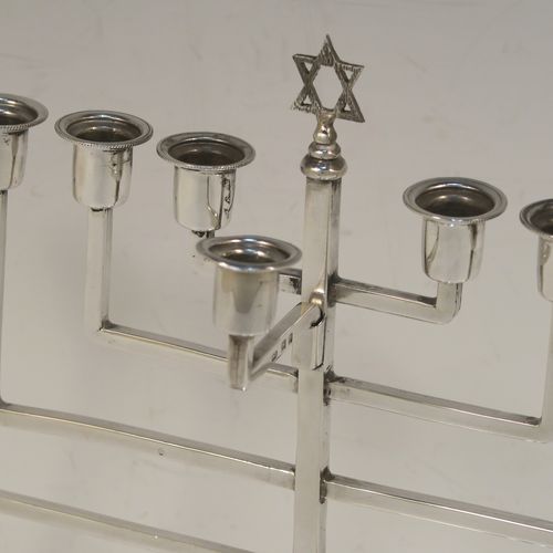 A small but very elegant Sterling Silver Hanukkah Menorah in an Art Deco style, having a plain square cross-section body with matching arms, a removable Shamus candle holder, and sitting on a plain round stepped pedestal foot. This handsome silver Menorah was made by Nathan Shore of London in 1926. The dimensions of this fine hand-made silver Hanukkah Menorah are height 18 cms (7 inches), spread across arms 19.7 cms (7.65 inches), and it weighs approx. 243g (7.8 troy ounces) Please note that this item is not filled so the whole weight is silver.   