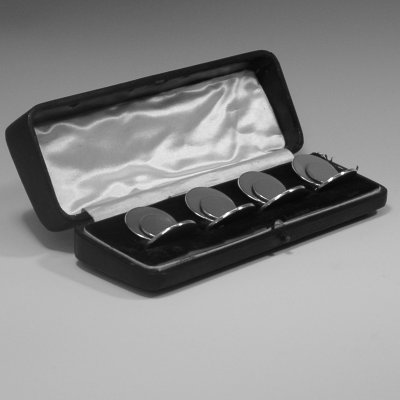 Sterling silver set of four place card holders made by Samuel Morden of Chester in 1913. Height 3 cms.