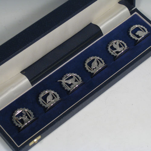 Sterling silver set of six place card holders with a hunting and shooting theme. Each one having a different animal including a retriever dog, pheasant, snipe, duck, partridge, and stag, and all in their original satin and velvet-lined presentation box. Made in London in 2000. Diameter of bases 3 cms (1.3 inches). Total weight approx. 79g (2.5 troy ounces).