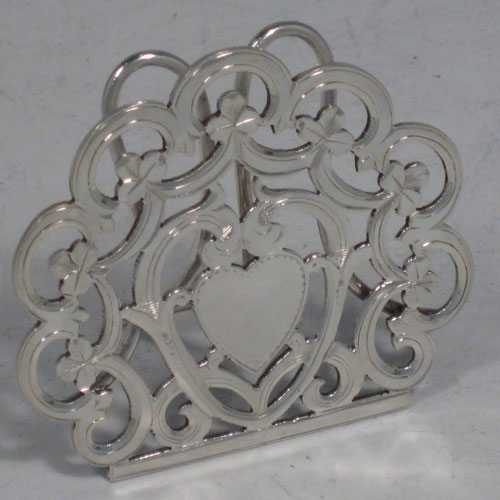 Antique Victorian sterling silver set of four menu or place card holders, having hand-pierced work with scrolls, three-leaf clovers, and heart-shaped cartouches. Please note that two are made in Birmingham in 1899, and two are marked sterling made in ca. 1890. Height 5 cms (2 inches), width 5 cms (2 inches). Total weight approx. 78g (2.5 troy ounces).