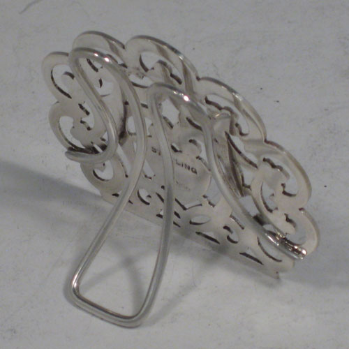 Antique Victorian sterling silver set of four menu or place card holders, having hand-pierced work with scrolls, three-leaf clovers, and heart-shaped cartouches. Please note that two are made in Birmingham in 1899, and two are marked sterling made in ca. 1890. Height 5 cms (2 inches), width 5 cms (2 inches). Total weight approx. 78g (2.5 troy ounces).