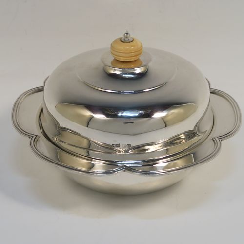 An elegant Sterling Silver muffin dish, having a round body with an applied and shaped reeded petal border, a domed lift-off lid with a bone finial, an original internal liner, and all sitting on a flat base. This beautiful silver caviar or muffin dish was made by Mappin and Webb of Sheffield in 1926. The dimensions of this fine hand-made silver muffin or caviar dish are diameter 18 cms (7 inches), height 10 cms (4 inches), and it weighs approx. 550g (17.7 troy ounces).

   