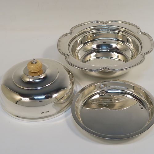 An elegant Sterling Silver muffin dish, having a round body with an applied and shaped reeded petal border, a domed lift-off lid with a bone finial, an original internal liner, and all sitting on a flat base. This beautiful silver caviar or muffin dish was made by Mappin and Webb of Sheffield in 1926. The dimensions of this fine hand-made silver muffin or caviar dish are diameter 18 cms (7 inches), height 10 cms (4 inches), and it weighs approx. 550g (17.7 troy ounces).

   